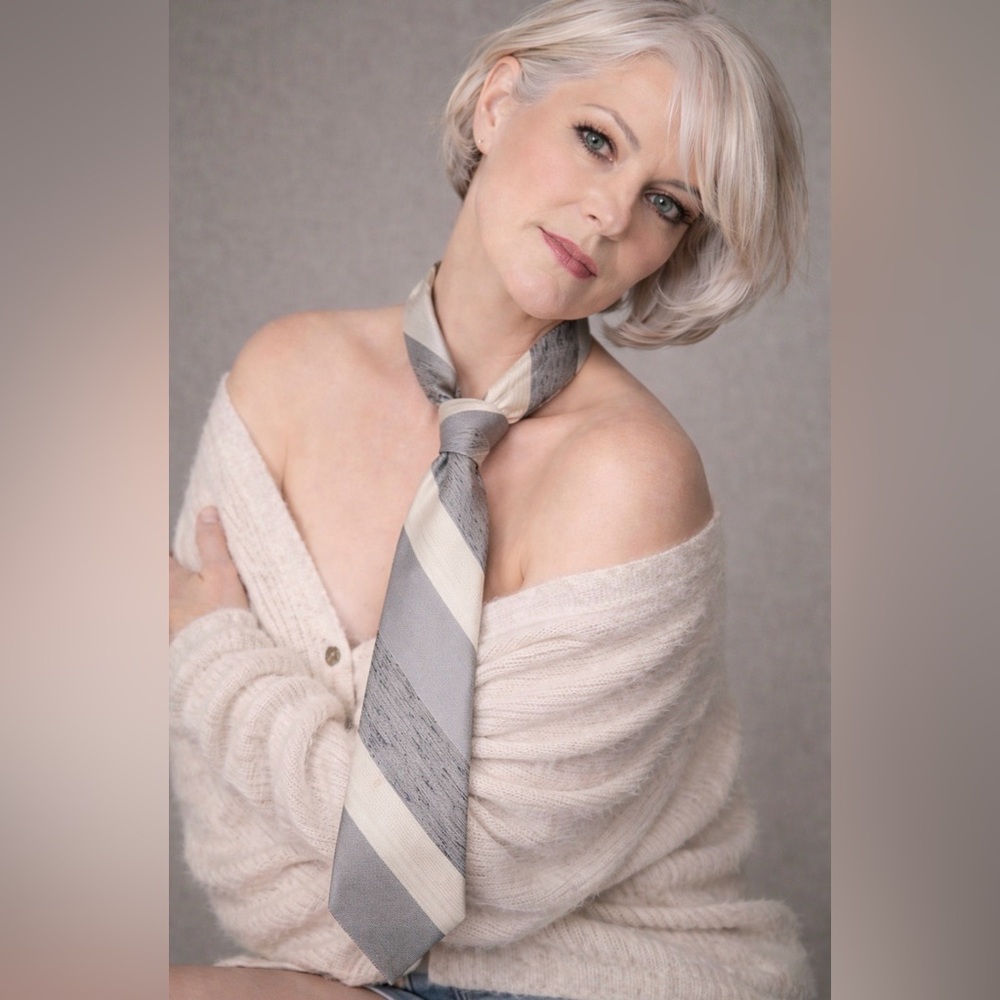 💯 % polyester TIE. It’s different shades of gray and cream, striped narrow